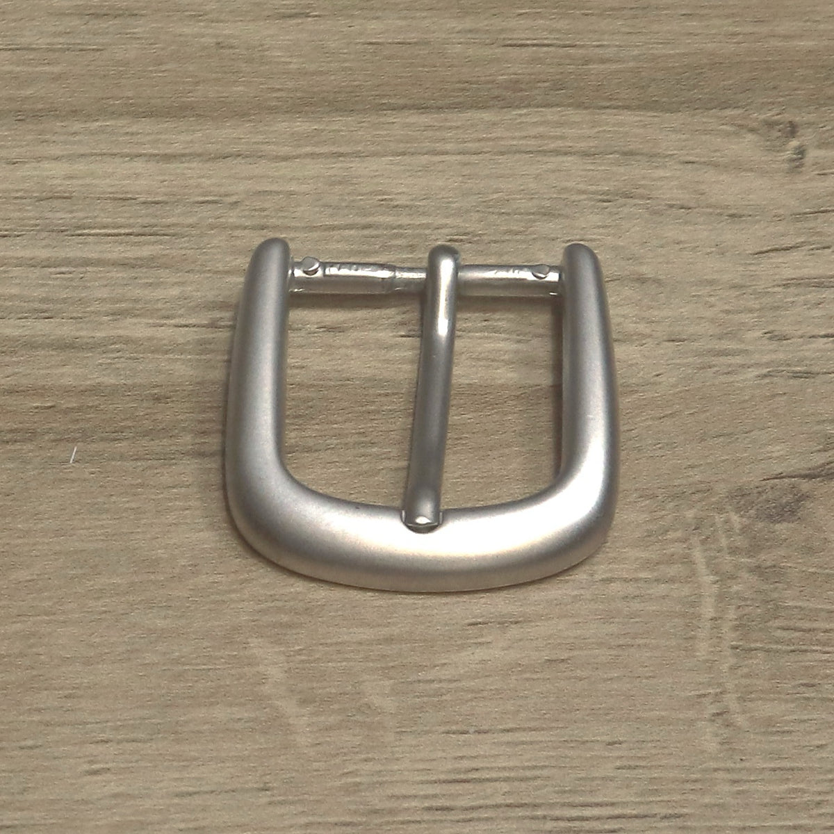 Belt buckle from above with the heel bar at the top, showing the pin hinge