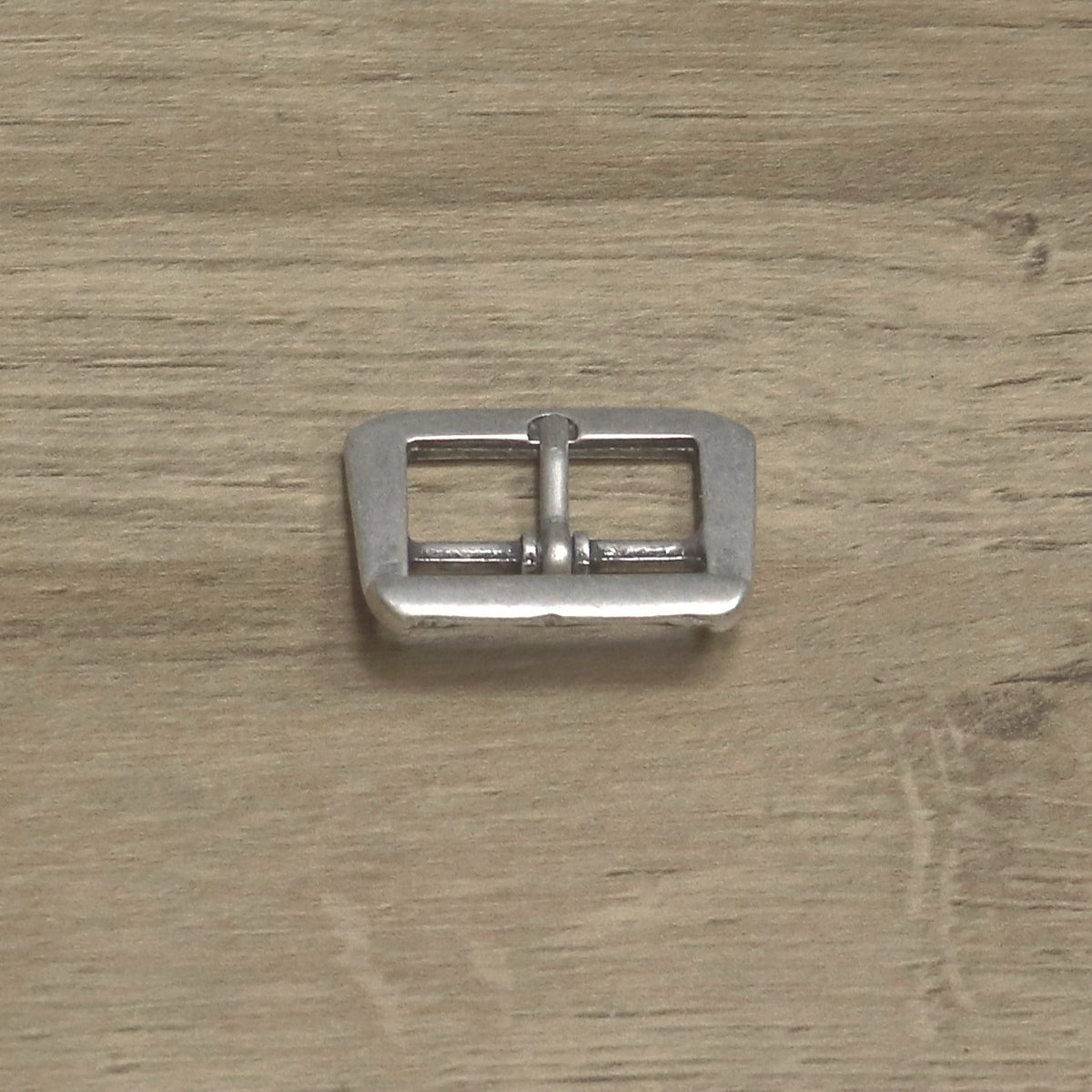 Cast centre bar buckle from above with the pin pointing up