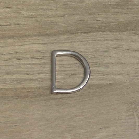 Nickel-plated one-piece D ring from above, flat straight bar on the left