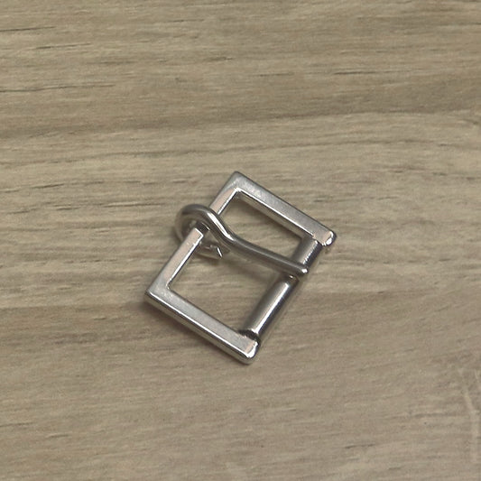 Nickel-plated cast buckle with a squared frame, at an angle with the pin resting on the roller