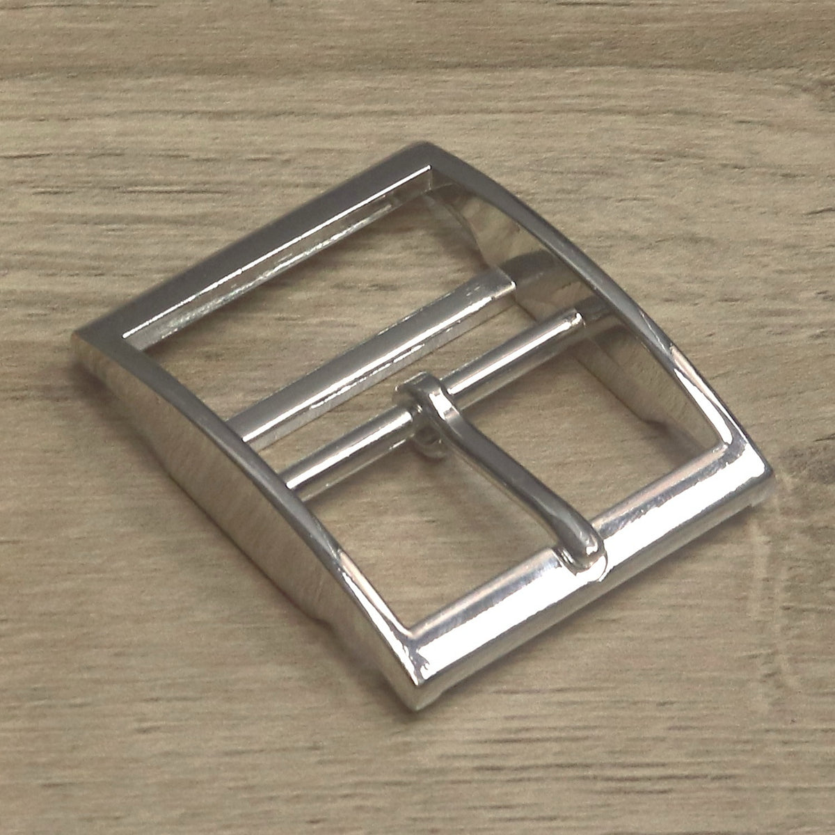 Nickel-plated double bar buckle angled to show the depth of the cast frame
