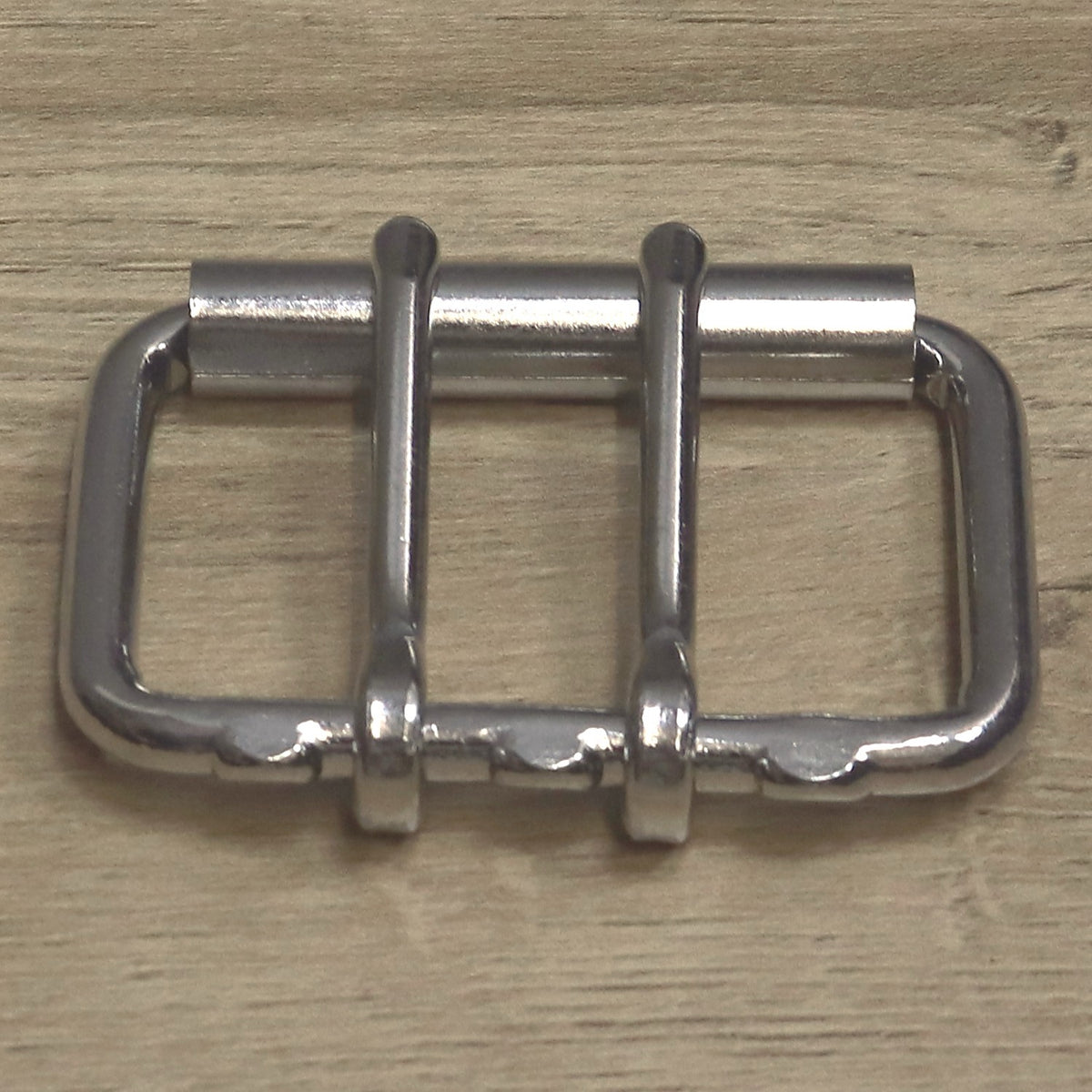 Double prong roller buckle from above with the roller at the top