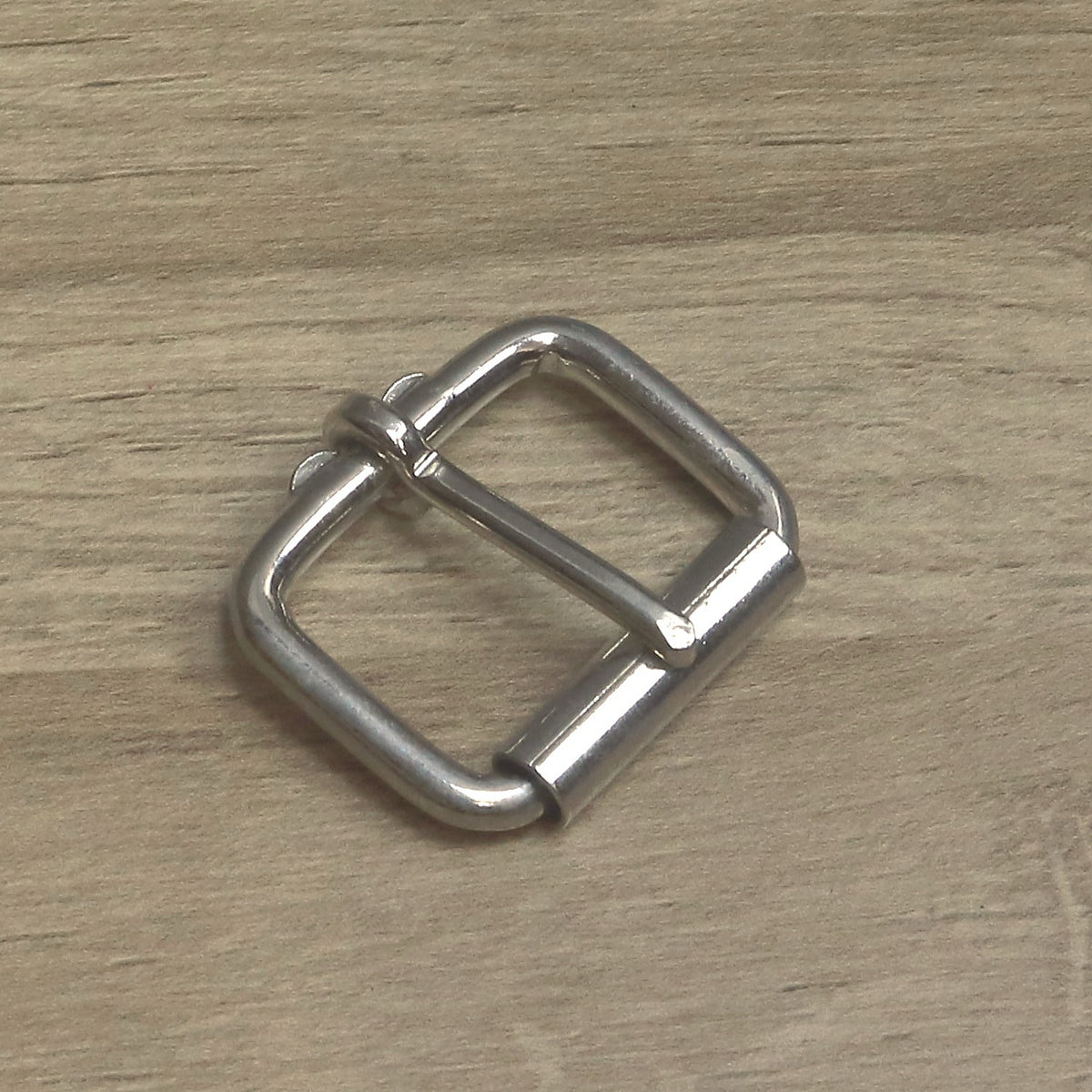 Nickel-plated heavy wire roller buckle for a 35mm strap, angled with the pin resting on the roller