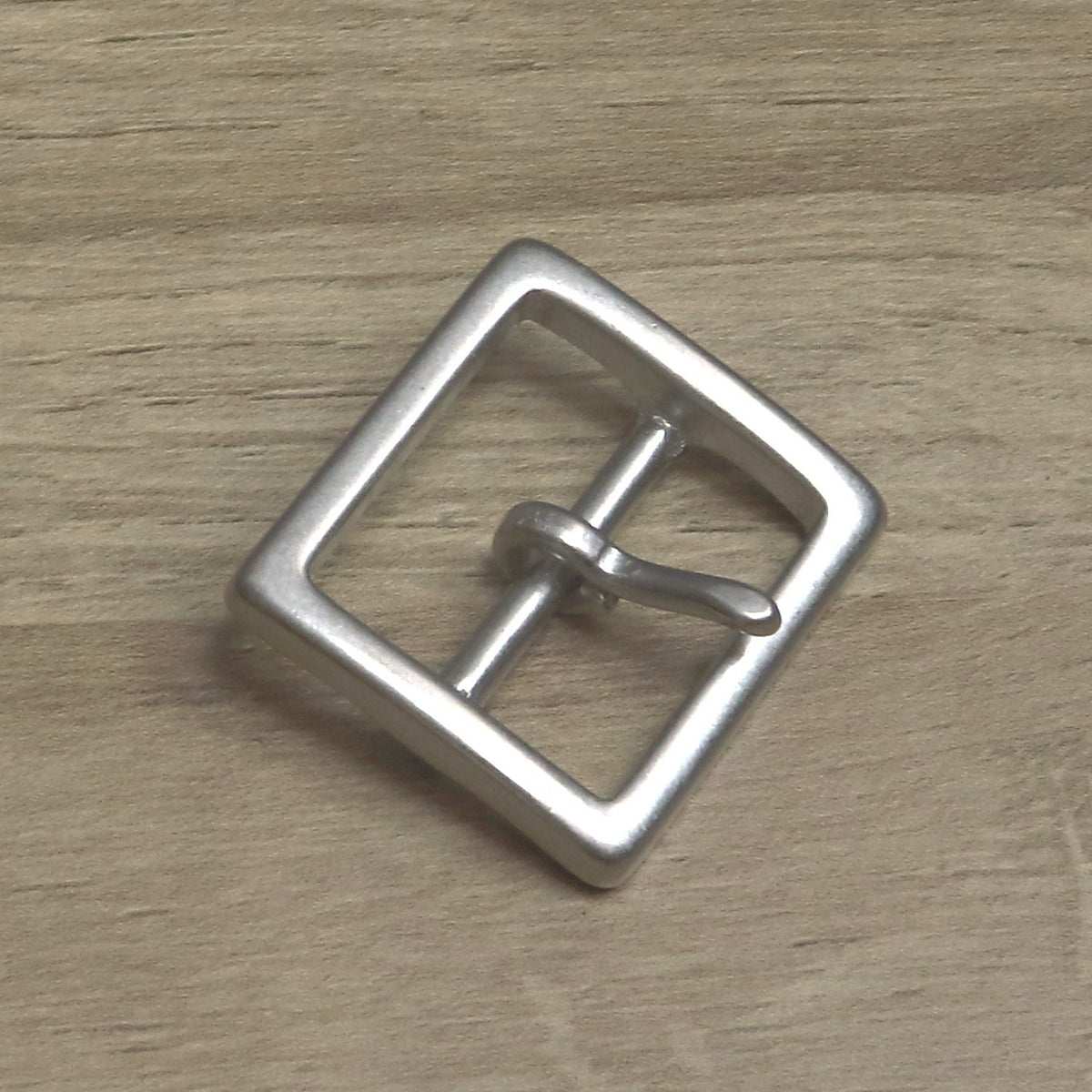 Satin antique nickel square buckle at an angle, pin resting on the front bar